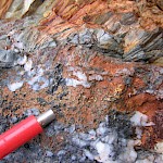 Cross-cutting quartz carbonate bonanza coarse gold and multi-kilos silver vein in outcrop within the south zone. Telluride minerals are suspected. Numerous bonanza precious metal and MS float boulders have been exposed with glacial ice melt back.