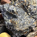 Crackle texture vuggy dravite cement tourmaline matrix. Sulphide-bearing tourmaline breccia.