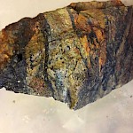 Rock showing a mix of quartz, sulphides, and black tourmaline breccia Sulphide tourmaline veins and breccia hosted in diorite intrusion.